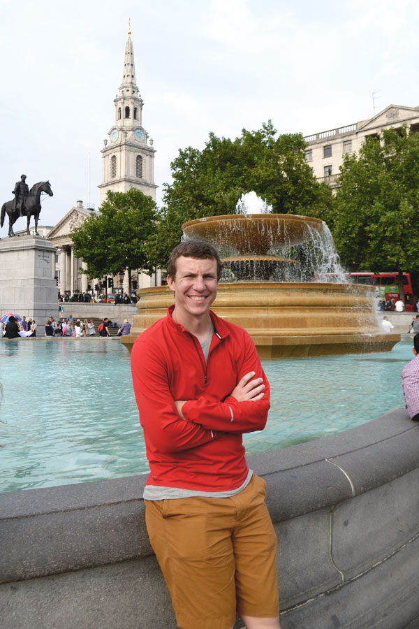 Cale standing near fountain in Trafalgar Square in London