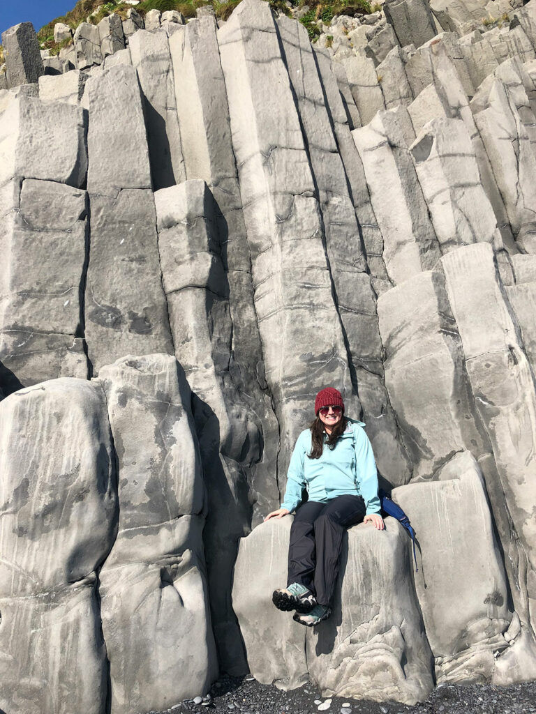 katie sitting on basalt rocks in Iceland